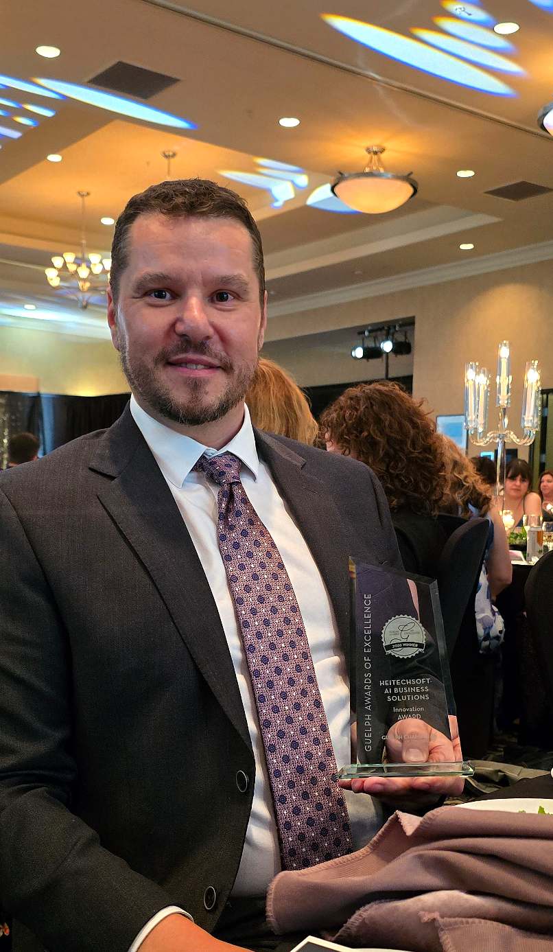 HeitechSoft representative holding the Guelph Awards of Excellence Innovation Award at the ceremony